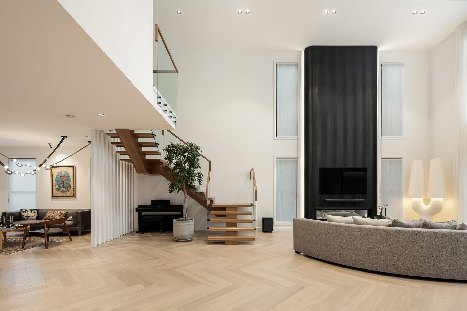 Double-height great room with stair and herringbone floor