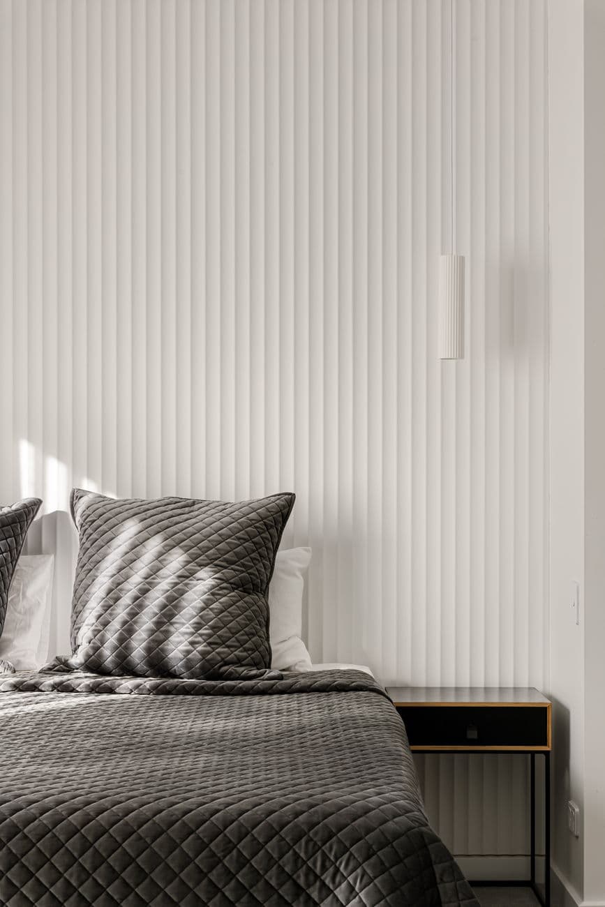 Fluted wall panelling and bedding detail